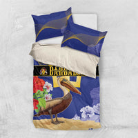 Blue bedding set flat lay: duvet cover with pelican and flowers, gold trident emblem, two pillowcases