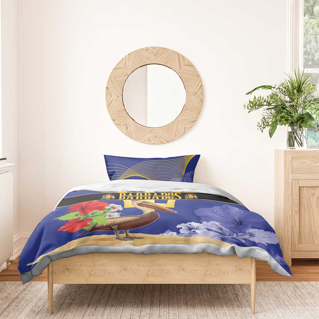 Blue bedding set on bed with pelican and flowers, gold trident emblem on duvet; two pillowcases
