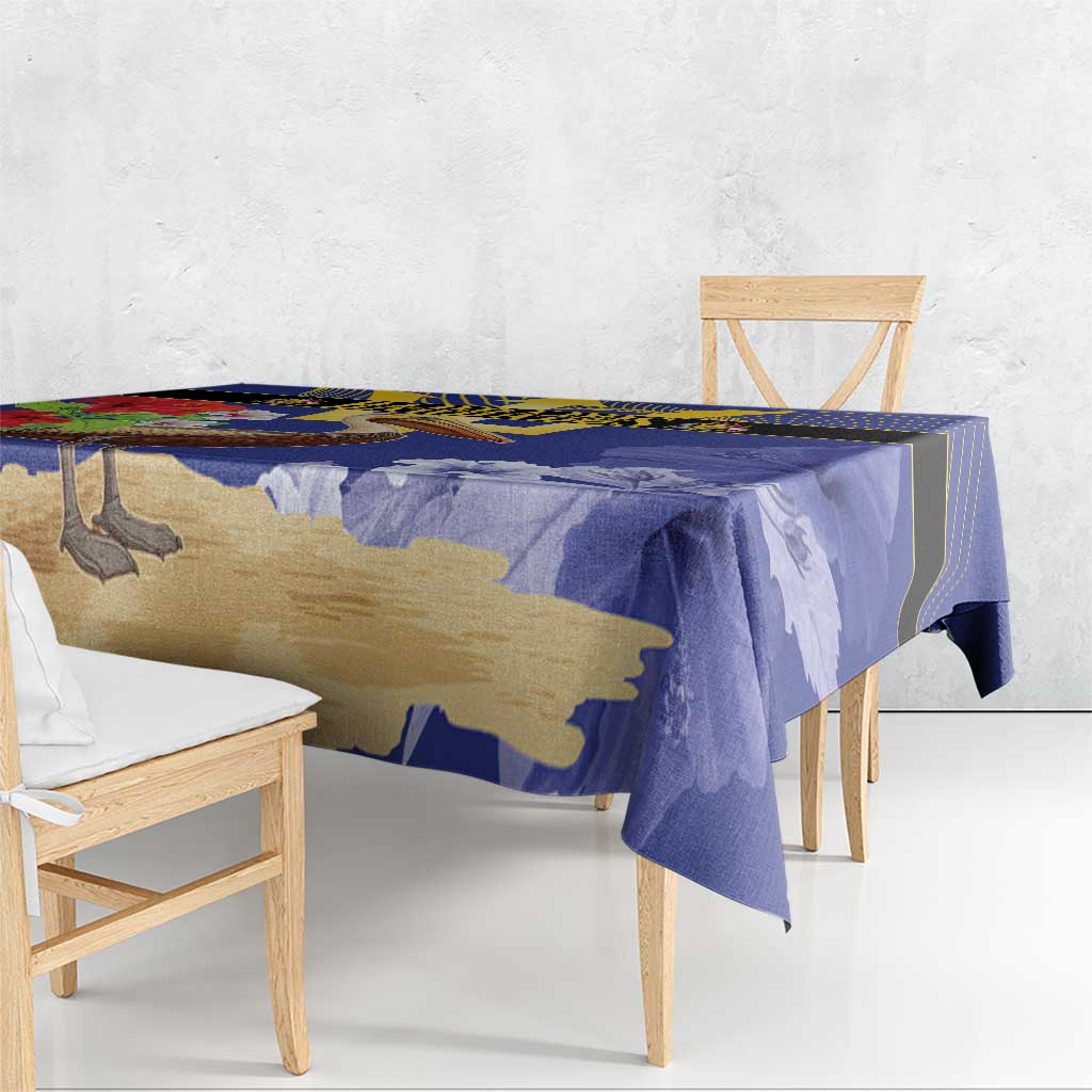 Blue tablecloth draped over dining table with pelican and trident graphic