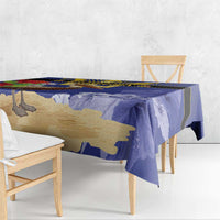 Blue tablecloth draped over dining table with pelican and trident graphic