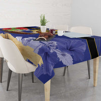 Blue tablecloth with large map shapes and pelican/trident motifs across table