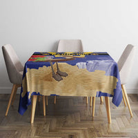 Blue and tan tablecloth with pelican and trident center design on dining table