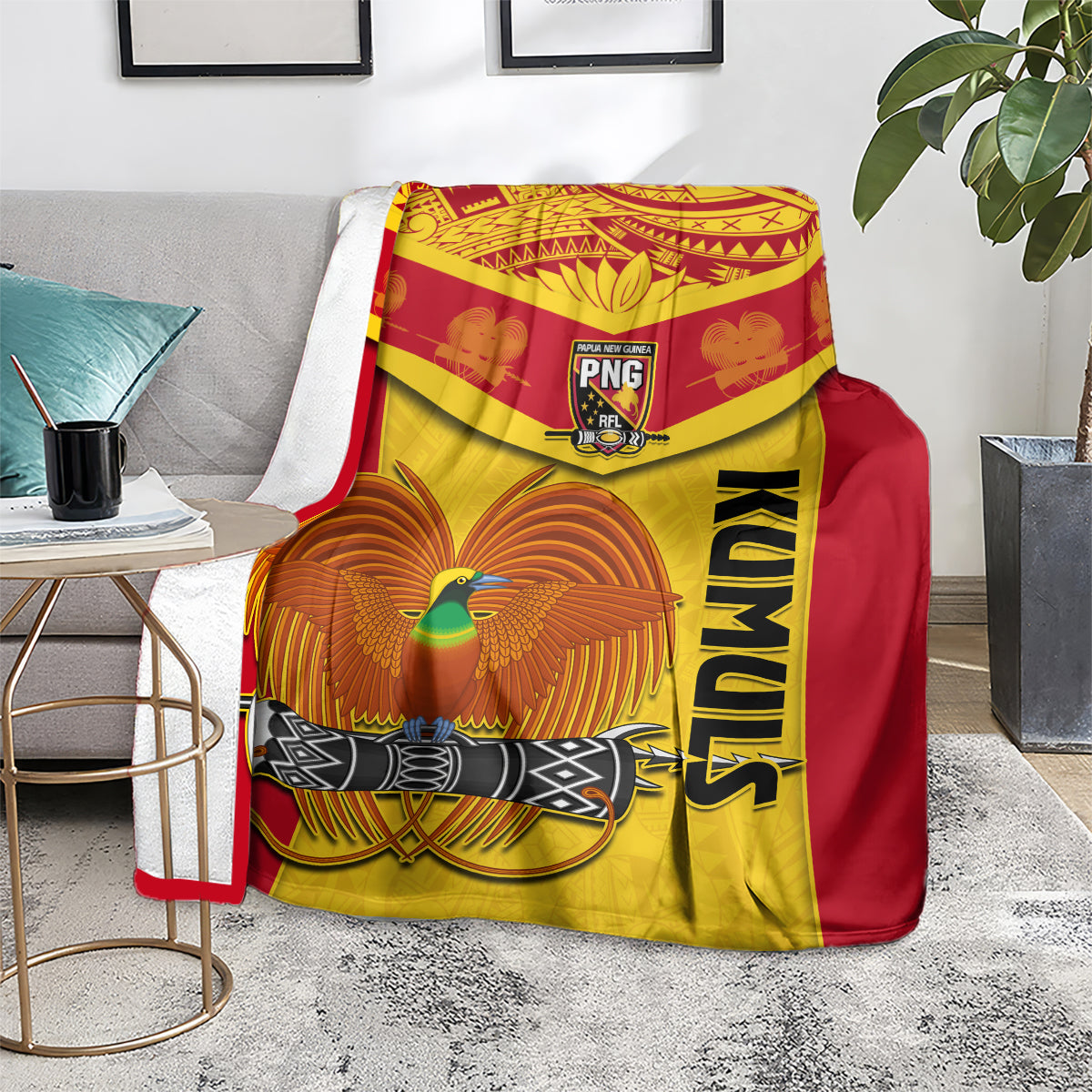 Rugby blanket in red and yellow featuring PNG crest, feathered bird art, and KUMUL lettering
