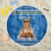 Round blue Christmas beach blanket with fringed edge and Santa Lucia graphic