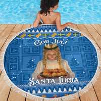 Round blue Santa Lucia beach blanket with fringed edge and “God Jul!” text