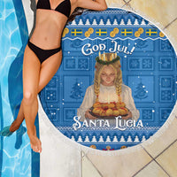 Round blue beach blanket with fringed edge and Santa Lucia figure print