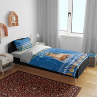 Blue Christmas bedding set on bed: Santa Lucia duvet with God Jul print