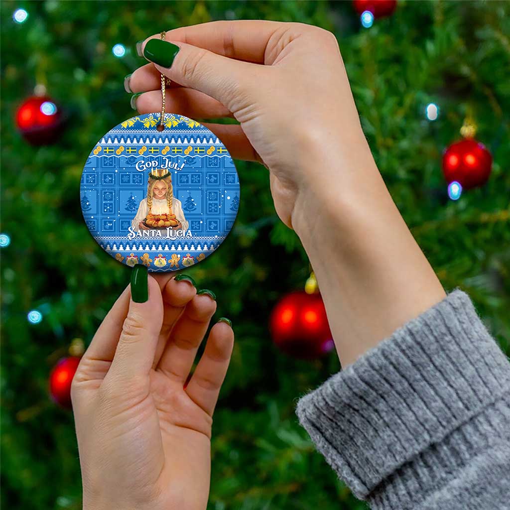 Blue round ceramic ornament with gold string, “God Jul!” and “Santa Lucia” on front.