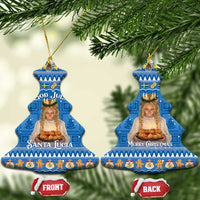 Two blue bell-shaped ceramic ornaments with gold strings: “Santa Lucia” and “Merry Christmas”.
