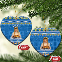 Two blue heart-shaped ceramic ornaments with gold strings: “Santa Lucia” and “Merry Christmas”.