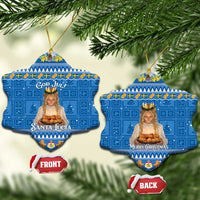Two blue shield-shaped ceramic ornaments with gold strings: “Santa Lucia” and “Merry Christmas”.