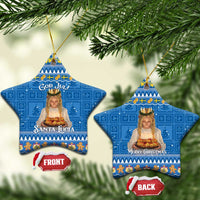 Two blue star-shaped ceramic ornaments with gold strings: “Santa Lucia” and “Merry Christmas”.