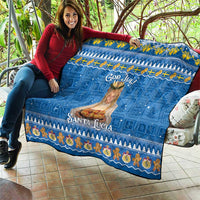 Blue God Jul Santa Lucia quilt held outdoors, with central saint print and decorative border.