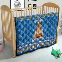 Blue God Jul Santa Lucia quilt on wooden crib, with central saint image and holiday border.