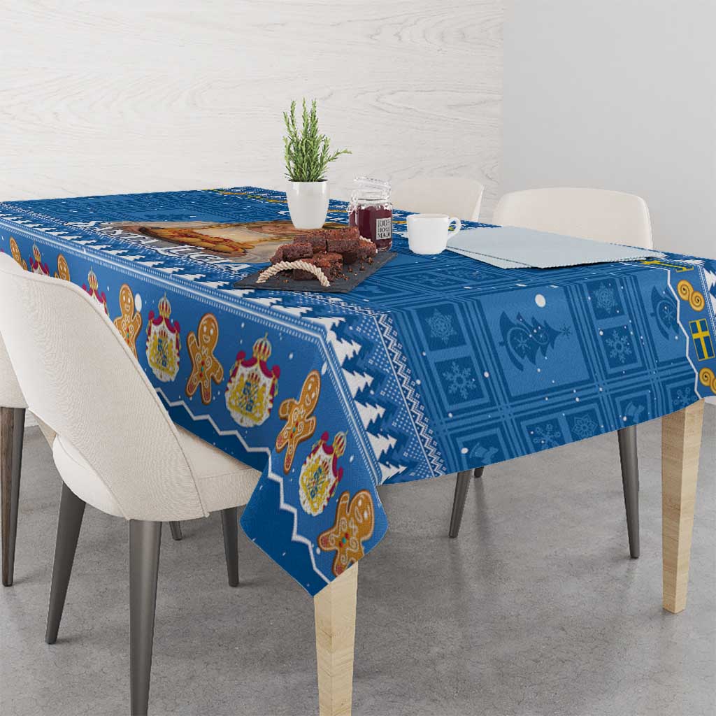 Blue holiday tablecloth with repeating gingerbread figures and snowy border on dining table
