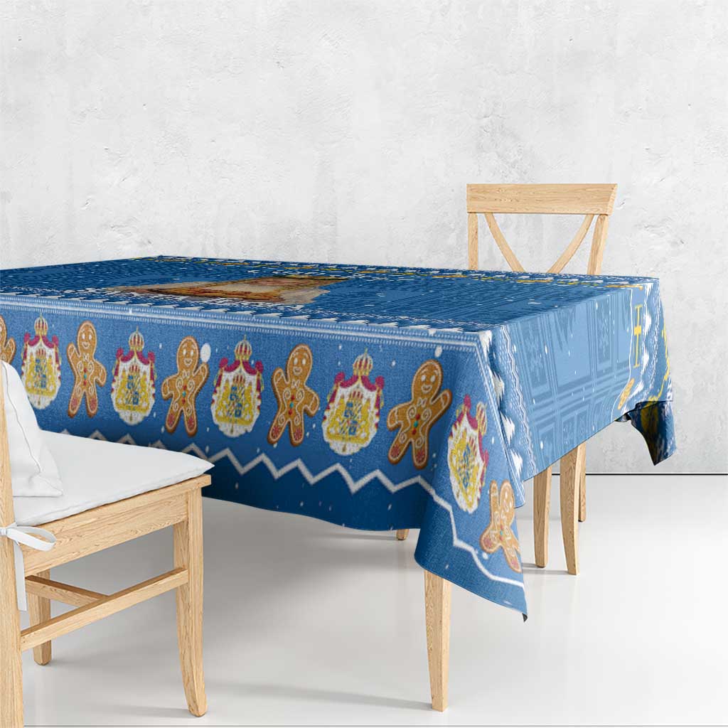 Blue holiday tablecloth draped over table edge with gingerbread figure motif