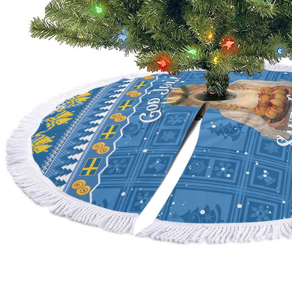 Blue circular Christmas tree skirt with God Jul! text and Santa Lucia figures, white fringe