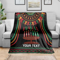 Black Kwanzaa kinara candle personalized blanket draped on sofa, with multicolor border