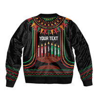 Black bomber jacket with kinara candles and 'YOUR TEXT' on back, zip front, striped trim