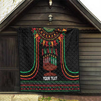 Black personalized Kwanzaa quilt blanket hanging on wall with candleholder graphic
