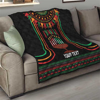 Black personalized Kwanzaa quilt blanket on sofa with candleholder artwork and “YOUR TEXT”