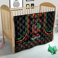 Black personalized Kwanzaa quilt blanket on crib with candleholder graphic and “YOUR TEXT”