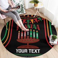 Black round Kwanzaa carpet, angled view, with candle graphic, multicolor stripes, 'YOUR TEXT'