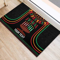Black Kwanzaa doormat with kinara candles, colorful arches, and 'YOUR TEXT'
