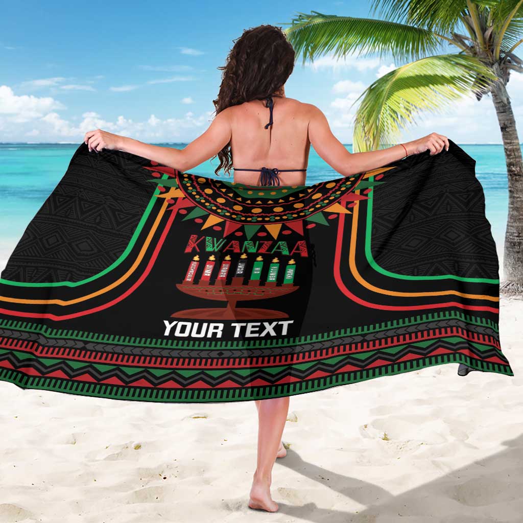 Black Kwanzaa sarong fully spread, green red stripe border and kinara candle graphic