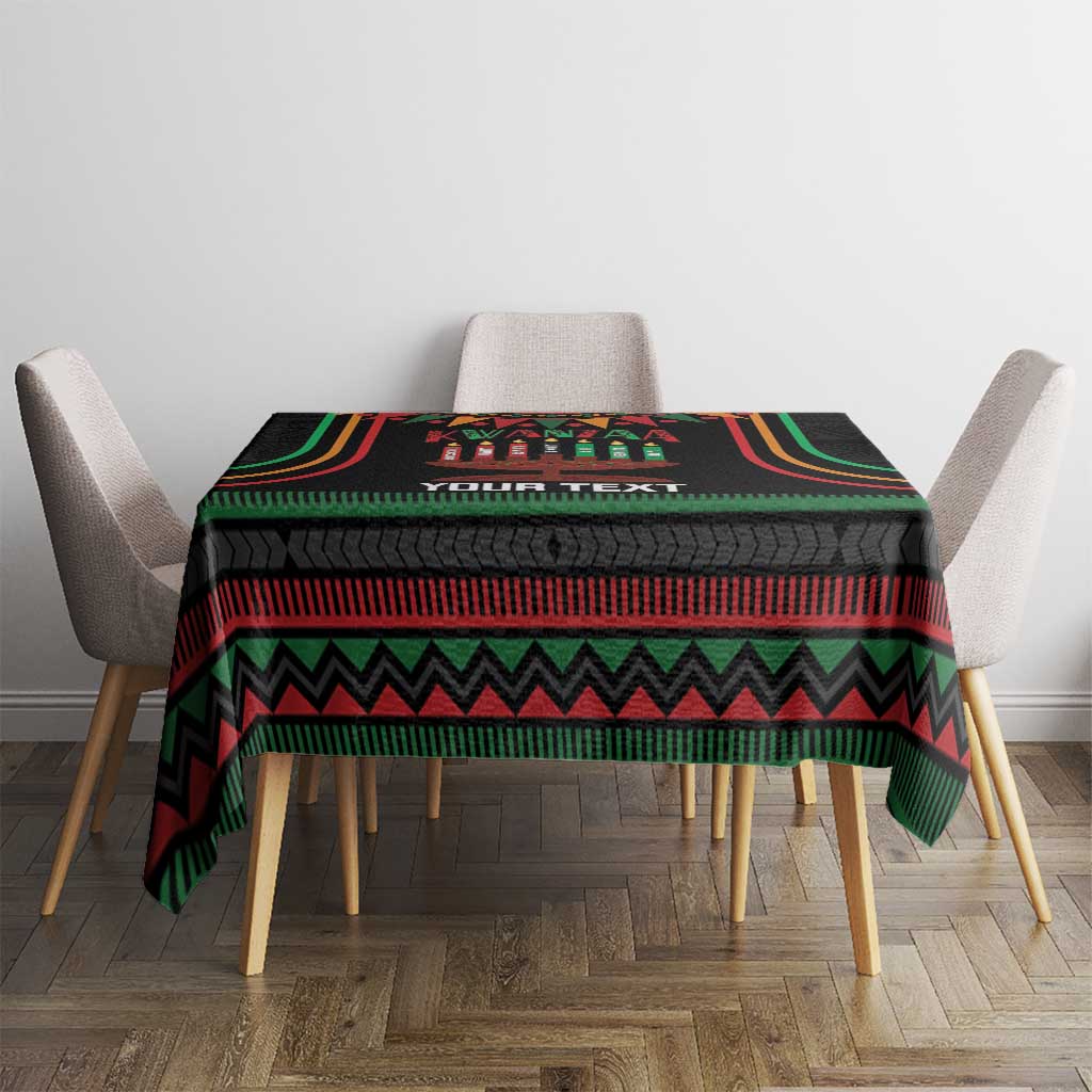 Black Kwanzaa tablecloth with colorful patterned center and zigzag border