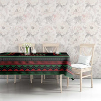 Black Kwanzaa tablecloth with colorful kinara stripe design on long dining table