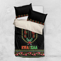 Black and white layered bedding set with two pillows, dashiki-style emblem and “KWANZAA” text