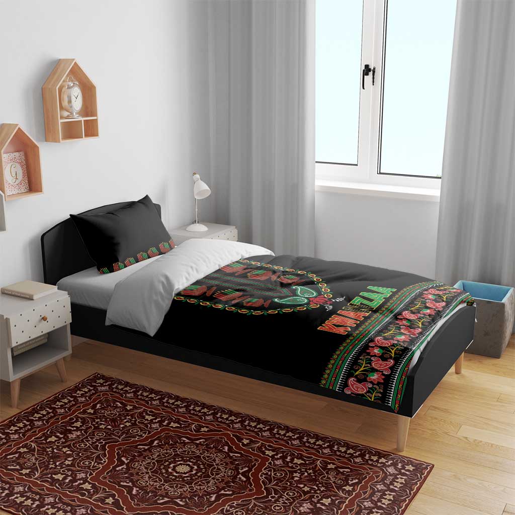Black Kwanzaa duvet on bed with pillows, colorful dashiki-style center print and patterned edge