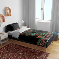 Black Kwanzaa duvet on bed with pillows, colorful dashiki-style center print and patterned edge