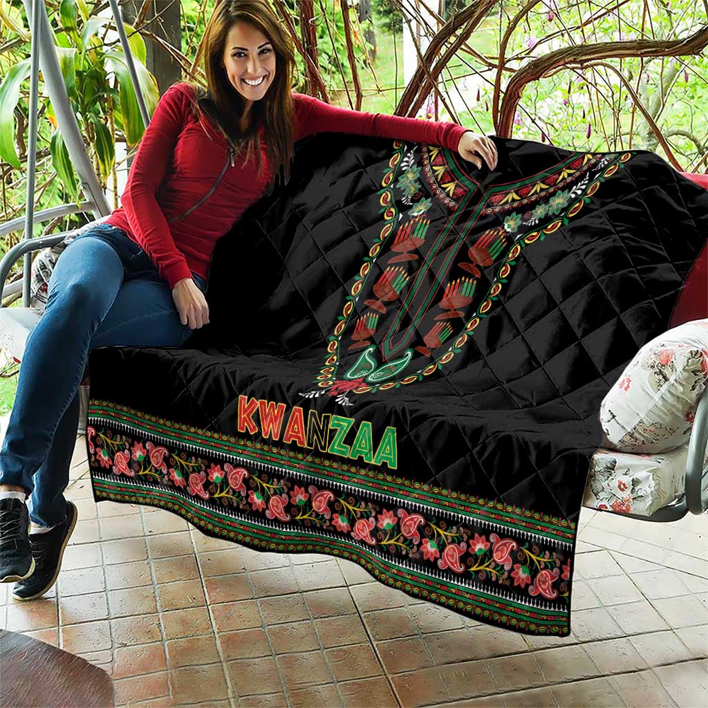 Black quilt draped on couch with dashiki neckline artwork, KWANZAA text, and border