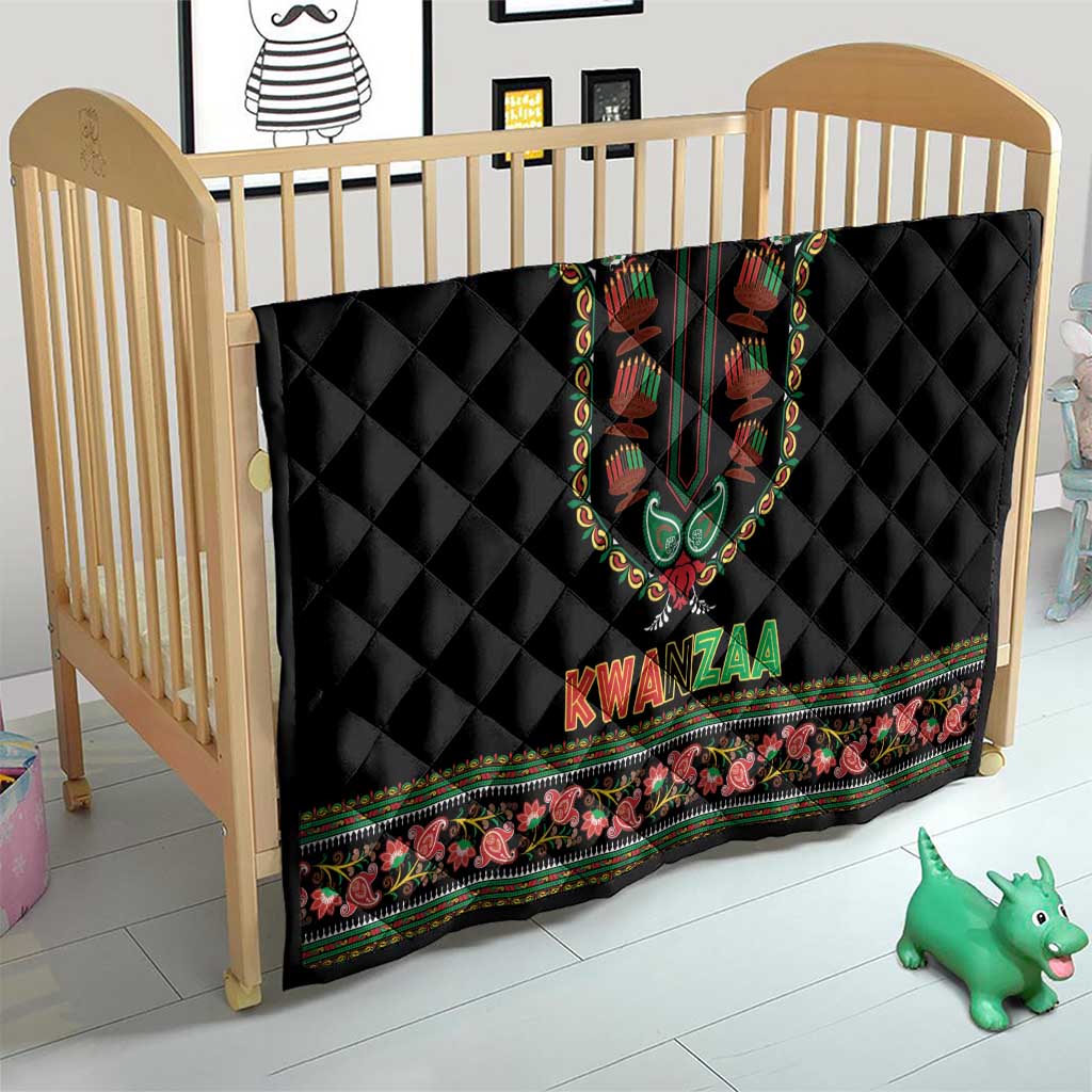 Black Kwanzaa quilt laid on crib with colorful dashiki panel, KWANZAA text, and border