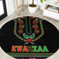 Black round Kwanzaa carpet with central emblem and colorful KWANZAA lettering