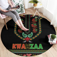 Black round Kwanzaa carpet with bold central design and KWANZAA text