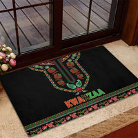 Black rubber doormat on porch with Kwanzaa candles and red "KWANZAA" across decorative edge