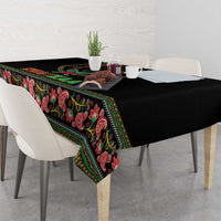 Black tablecloth draped on table with colorful paisley pattern and striped border