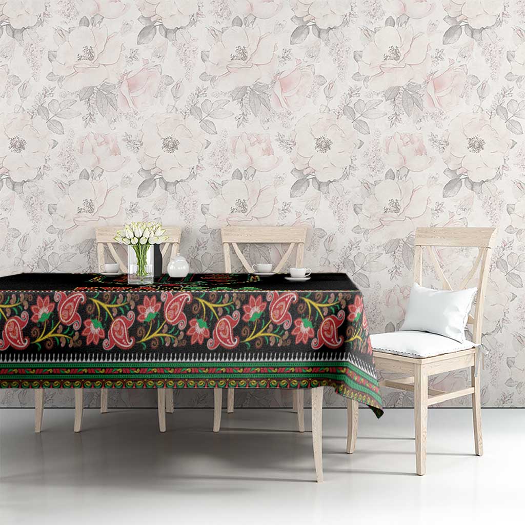 Black tablecloth with colorful paisley border and repeating edge stripe design