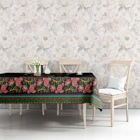 Black tablecloth with colorful paisley border and repeating edge stripe design