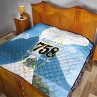 Blue and white quilt on bed showing Saint Lucia logo and “758”