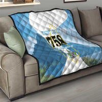 Blue and white quilt draped on sofa with Saint Lucia logo and “758”