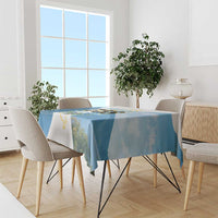 Blue tablecloth with Saint Lucia 758 island map and scenic mountain print, draped on dining table