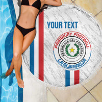 Paraguay football beach blanket, white round fringed towel with crest and tricolor stripes, draped.