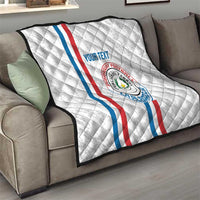 White custom quilt on a sofa with Paraguay flag stripes, crest emblem, and “YOUR TEXT”