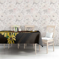 Black tablecloth with yellow flower and horse print across dining table