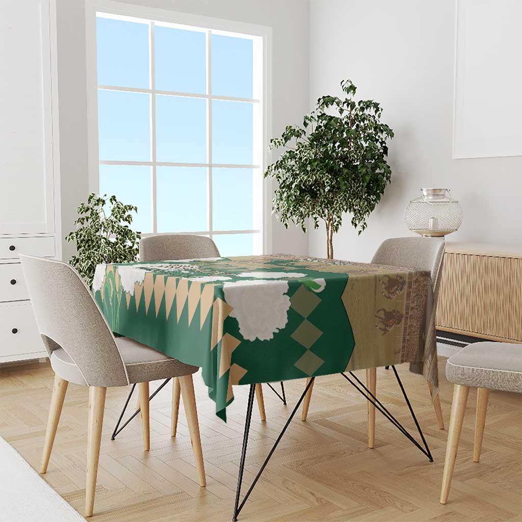 Green horse racing tablecloth with Belmont Stakes graphics across dining table