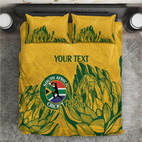 Yellow bedding set with green leafy pattern, South Africa Cricket Proteas logo, and “YOUR TEXT”